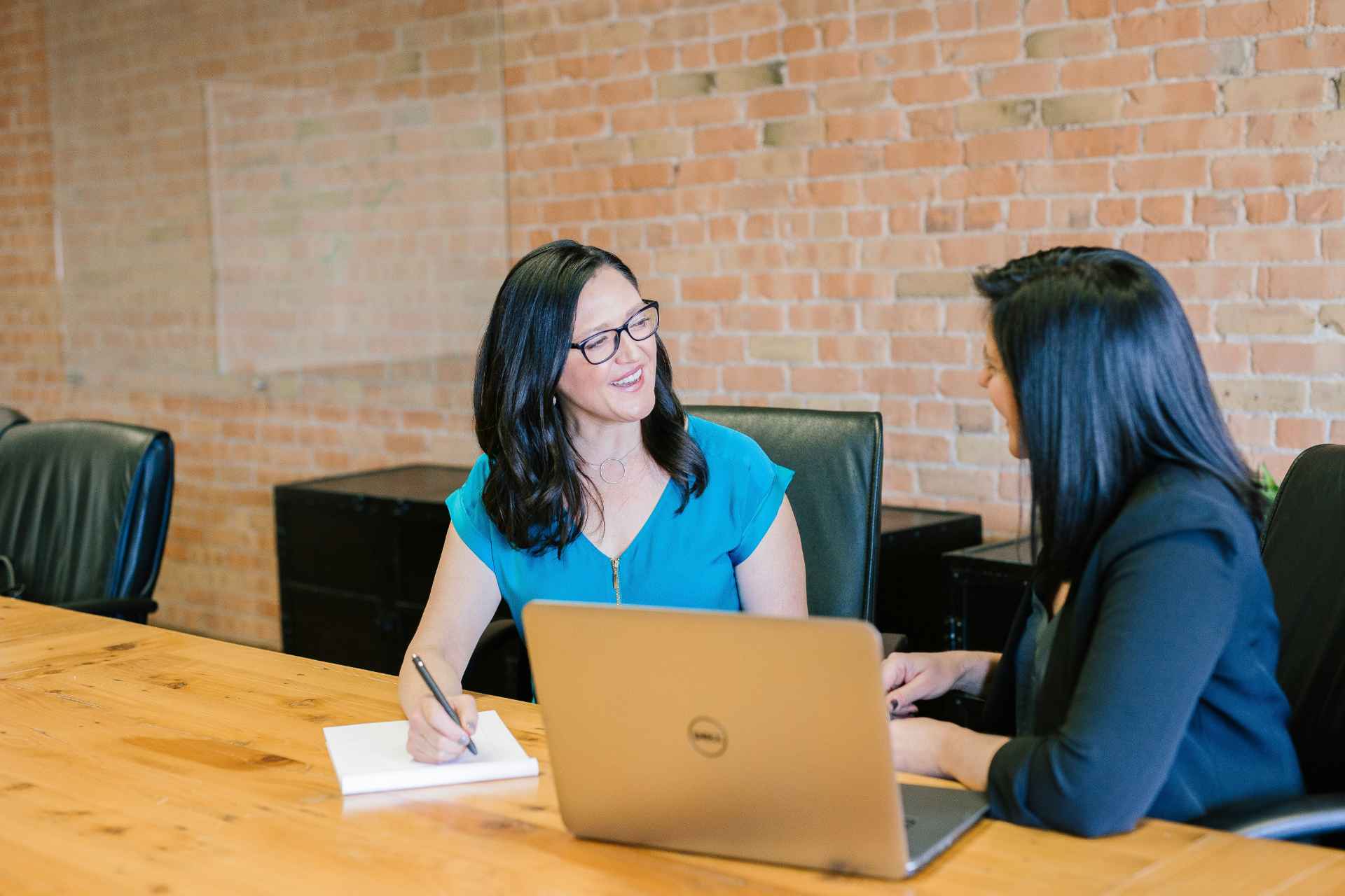 2 professional women meeting together with laptop in front of them