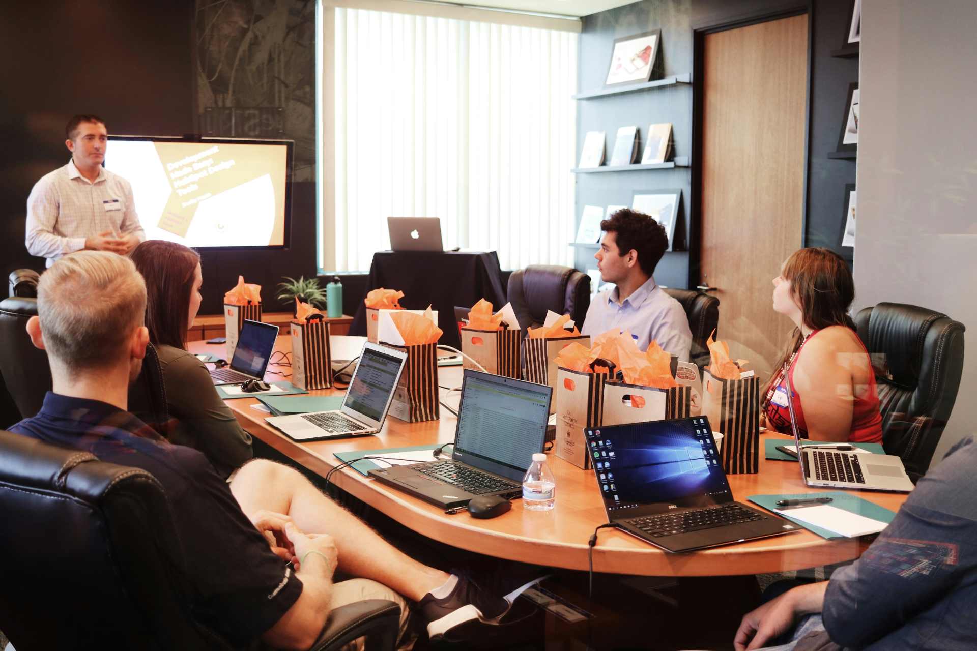 Professionals meeting around the table while working on their laptops